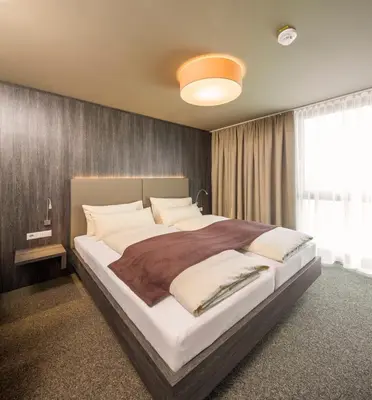 Ein Bett oder Betten in einem Zimmer der Unterkunft MYHOTEL München Olching