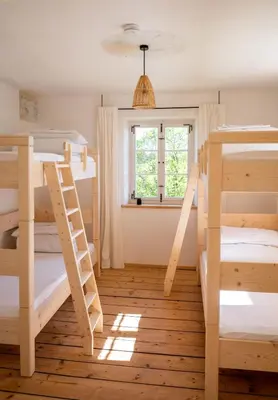 Ein Bett oder Betten in einem Zimmer der Unterkunft Pilgerhaus Wildsteig