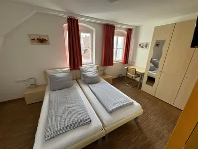 Ein Bett oder Betten in einem Zimmer der Unterkunft Hotel Stadtblick Friedberg
