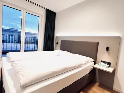 Ein Bett oder Betten in einem Zimmer der Unterkunft Mikes Apartments Munich