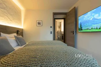 Ein Bett oder Betten in einem Zimmer der Unterkunft LIVALPIN Suite