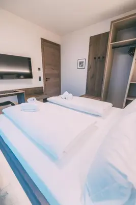 Ein Bett oder Betten in einem Zimmer der Unterkunft LIVALPIN Elegant