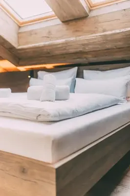 Ein Bett oder Betten in einem Zimmer der Unterkunft LIVALPIN Residence - with private Sauna & Whirlpool
