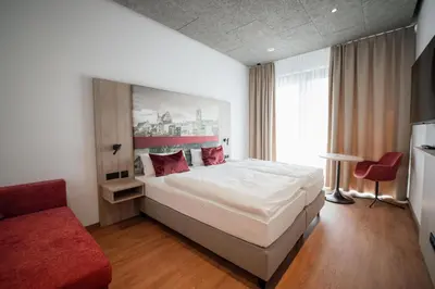 Ein Bett oder Betten in einem Zimmer der Unterkunft Das Wasserburg Hotel
