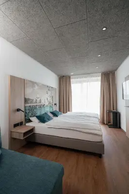 Ein Bett oder Betten in einem Zimmer der Unterkunft Das Wasserburg Hotel