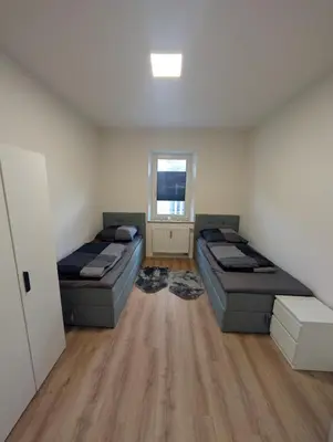 Ein Bett oder Betten in einem Zimmer der Unterkunft Schlössle Augsburg Lechhausen