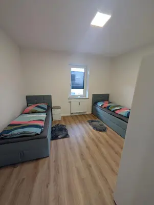 Ein Bett oder Betten in einem Zimmer der Unterkunft Schlössle Augsburg Lechhausen