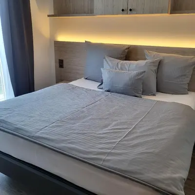 Ein Bett oder Betten in einem Zimmer der Unterkunft Bader Aparthotel