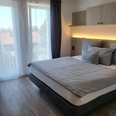 Ein Bett oder Betten in einem Zimmer der Unterkunft Bader Aparthotel