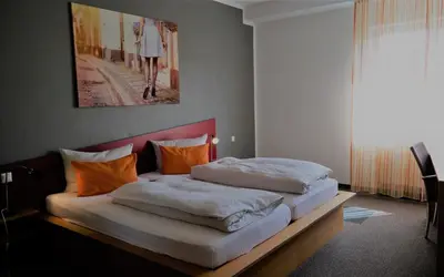 Ein Bett oder Betten in einem Zimmer der Unterkunft GS Hotel Mindelheim