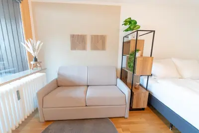 Ein Bett oder Betten in einem Zimmer der Unterkunft Zentrales Apartment mit Balkon direkt am Wanderweg - Alpenperle Tegernsee