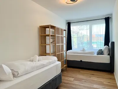 Ein Bett oder Betten in einem Zimmer der Unterkunft YUVA HOMES Germering - 100m2 - nahe München - 2 Bäder - S-Bahn