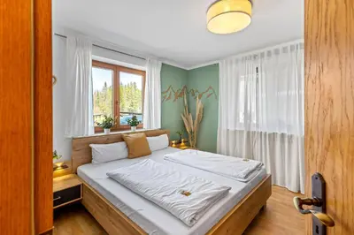 Ein Bett oder Betten in einem Zimmer der Unterkunft CASARiNA - Alpentraum am Barmsee - FeWo Lugge