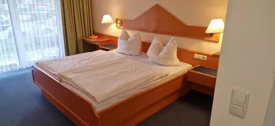 Ein Bett oder Betten in einem Zimmer der Unterkunft Studio Burghotel Aschau