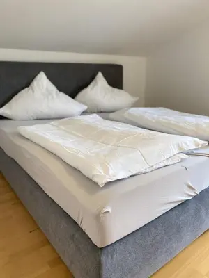 Ein Bett oder Betten in einem Zimmer der Unterkunft Ferienwohnung am Mühlbach