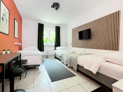 Ein Bett oder Betten in einem Zimmer der Unterkunft LTA Apartment Ingolstadt Irgertsheim-5 Schlafzimmer-Einzelbetten-WLAN-Waschmaschine