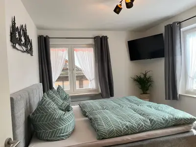 Ein Bett oder Betten in einem Zimmer der Unterkunft Ferienwohnung Dauberweiß