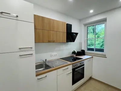 Küche/Küchenzeile in der Unterkunft AVINORA Modernes Apartment mit Balkon zwischen Chiemsee und Kampenwand
