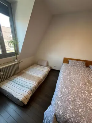 Ein Bett oder Betten in einem Zimmer der Unterkunft City-Apartment with private Rooftop Terrace