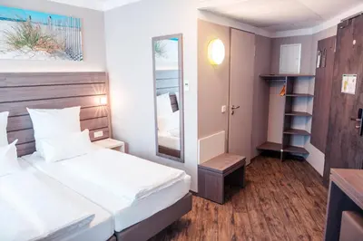 Ein Bett oder Betten in einem Zimmer der Unterkunft Tulip Inn München Messe