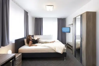 Ein Bett oder Betten in einem Zimmer der Unterkunft Hotel New In Guesthouse