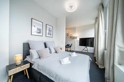 Ein Bett oder Betten in einem Zimmer der Unterkunft 2 Modern city studio for 6 Bogenhausen near Messe
