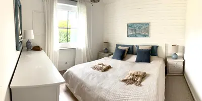 Ein Bett oder Betten in einem Zimmer der Unterkunft Chiemsee Häuschen