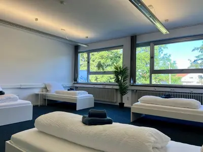 Ein Bett oder Betten in einem Zimmer der Unterkunft StayING - Die Unterkunft für Gruppen in Ingolstadt