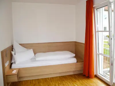 Ein Bett oder Betten in einem Zimmer der Unterkunft Apparthotel Ampertal