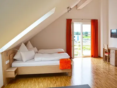 Ein Bett oder Betten in einem Zimmer der Unterkunft Apparthotel Ampertal