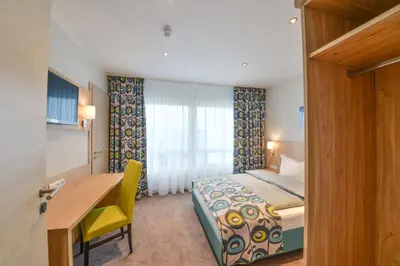 Ein Bett oder Betten in einem Zimmer der Unterkunft Ammi Hotel Garni