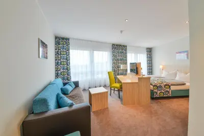 Ein Bett oder Betten in einem Zimmer der Unterkunft Ammi Hotel Garni