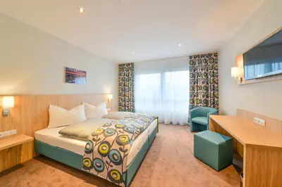 Ein Bett oder Betten in einem Zimmer der Unterkunft Ammi Hotel Garni