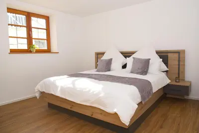 Ein Bett oder Betten in einem Zimmer der Unterkunft Ferienwohnung Alpenzeit Unterwössen im Chiemgau