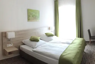 Ein Bett oder Betten in einem Zimmer der Unterkunft Landgasthof Hepting