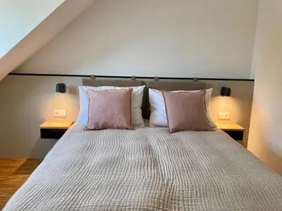 Ein Bett oder Betten in einem Zimmer der Unterkunft GRUNDLERS - Gästehaus am See