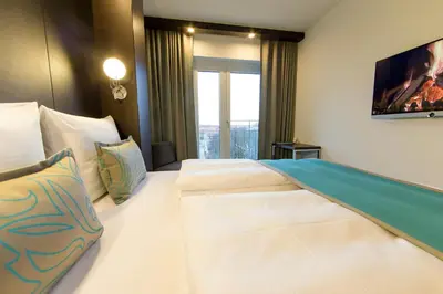 Ein Bett oder Betten in einem Zimmer der Unterkunft Motel One München-Olympia Gate
