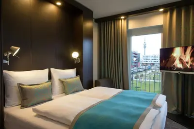 Ein Bett oder Betten in einem Zimmer der Unterkunft Motel One München-Olympia Gate