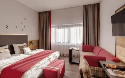 Ein Bett oder Betten in einem Zimmer der Unterkunft Hotel Traumschmiede
