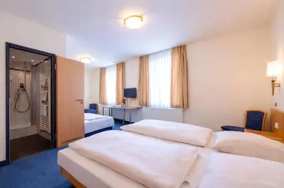 Ein Bett oder Betten in einem Zimmer der Unterkunft Hotel Wendelstein München City