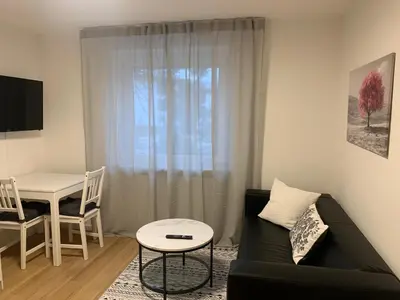 Ein Sitzbereich in der Unterkunft Modernes 1 Zimmer Appartement direkt am Wörthsee