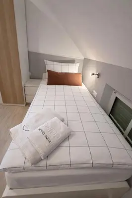 Ein Bett oder Betten in einem Zimmer der Unterkunft Hotel Aqua