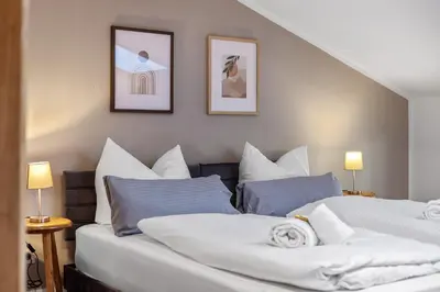 Ein Bett oder Betten in einem Zimmer der Unterkunft Design Apartment No 3 Gmund am Tegernsee by BALANCED