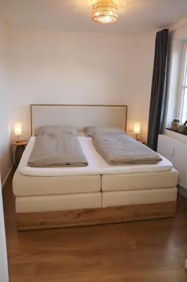 Ein Bett oder Betten in einem Zimmer der Unterkunft City Quartier 8 Traumlage Augsburg Zentrum