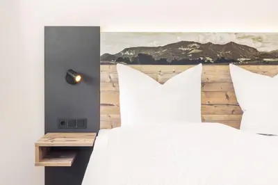 Ein Bett oder Betten in einem Zimmer der Unterkunft Alpen Lodge Samerberg