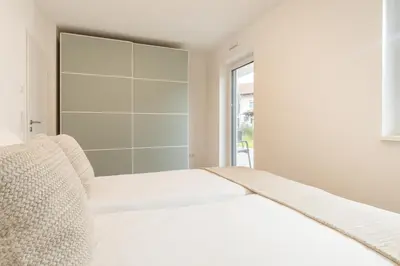 Ein Bett oder Betten in einem Zimmer der Unterkunft Chiemsee Apartment 17