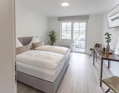 Ein Bett oder Betten in einem Zimmer der Unterkunft Pension Augsburg Ost