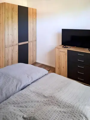 Ein Bett oder Betten in einem Zimmer der Unterkunft Moderne 4-Zimmer Ferienwohnung, Nähe Tegernsee