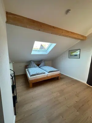 Ein Bett oder Betten in einem Zimmer der Unterkunft Ferienwohnung An der Leiten