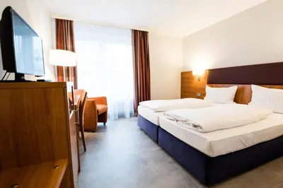 Ein Bett oder Betten in einem Zimmer der Unterkunft domus Hotel